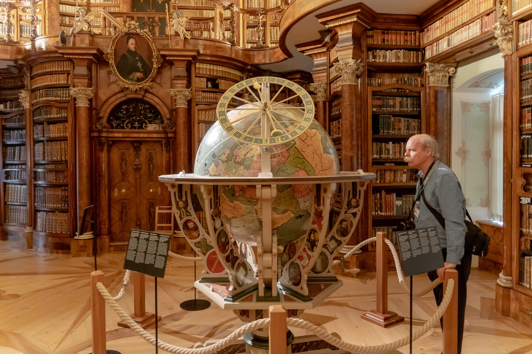 The ornate Abbey Library of St Gall in St.Gallen, with historic books and a celestial globe